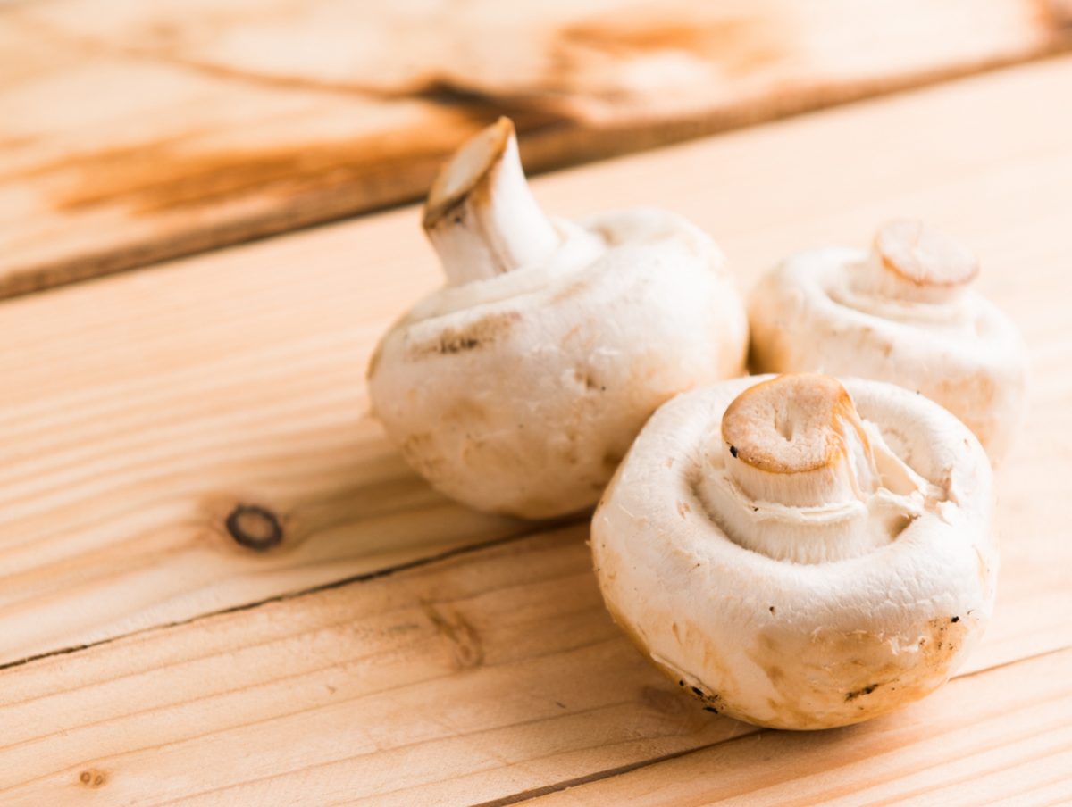 White button Mushrooms on a wood surface to Benefit Your Brain