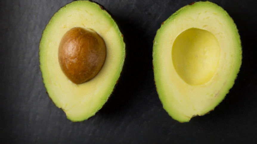 Avocados cut in half to show their nutritional value