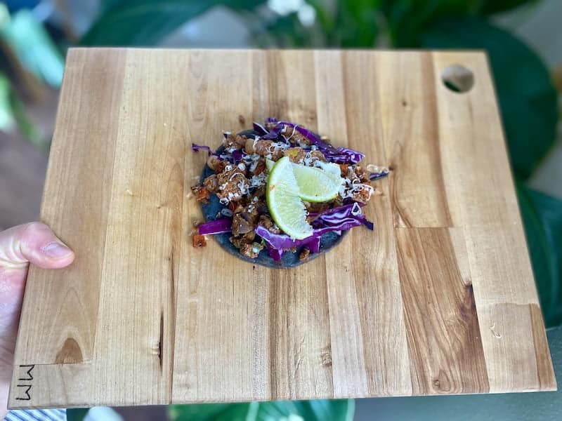 Beef tostada with homemade purple masa tortillas.