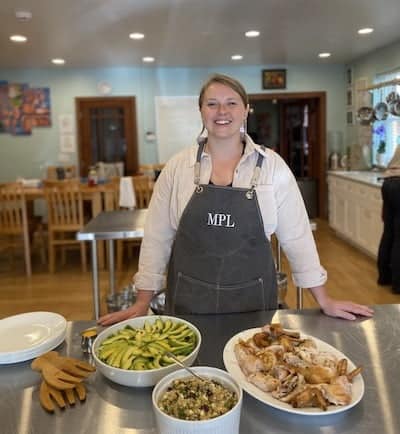 Maddie standing in the Natural Food Chef kitchen.