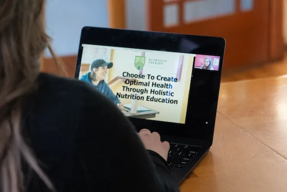 Future NTI student learning about nutrition certification programs through an online webinar.