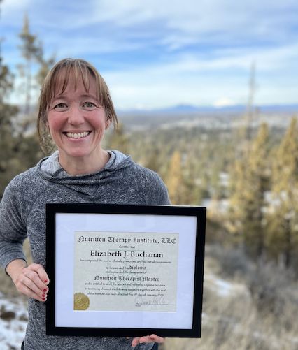 Certified holistic nutrition professional celebrating graduation from Nutrition Therapy Institute.