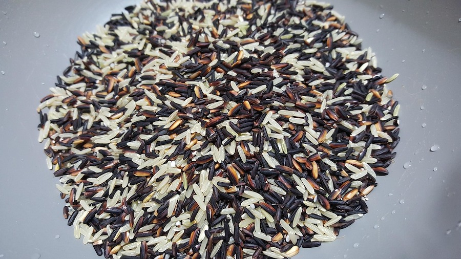Uncooked wild rice showcasing its dark color and texture, a nutrient-dense option among the health benefits of rice alternatives.