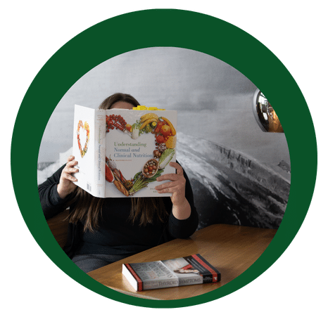 Student reading a text book about holistic nutrition.