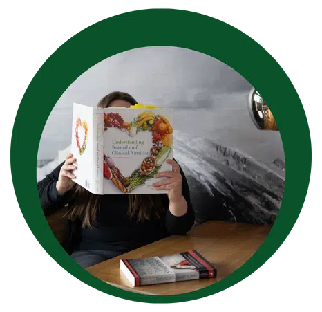 Student reading a text book about holistic nutrition.